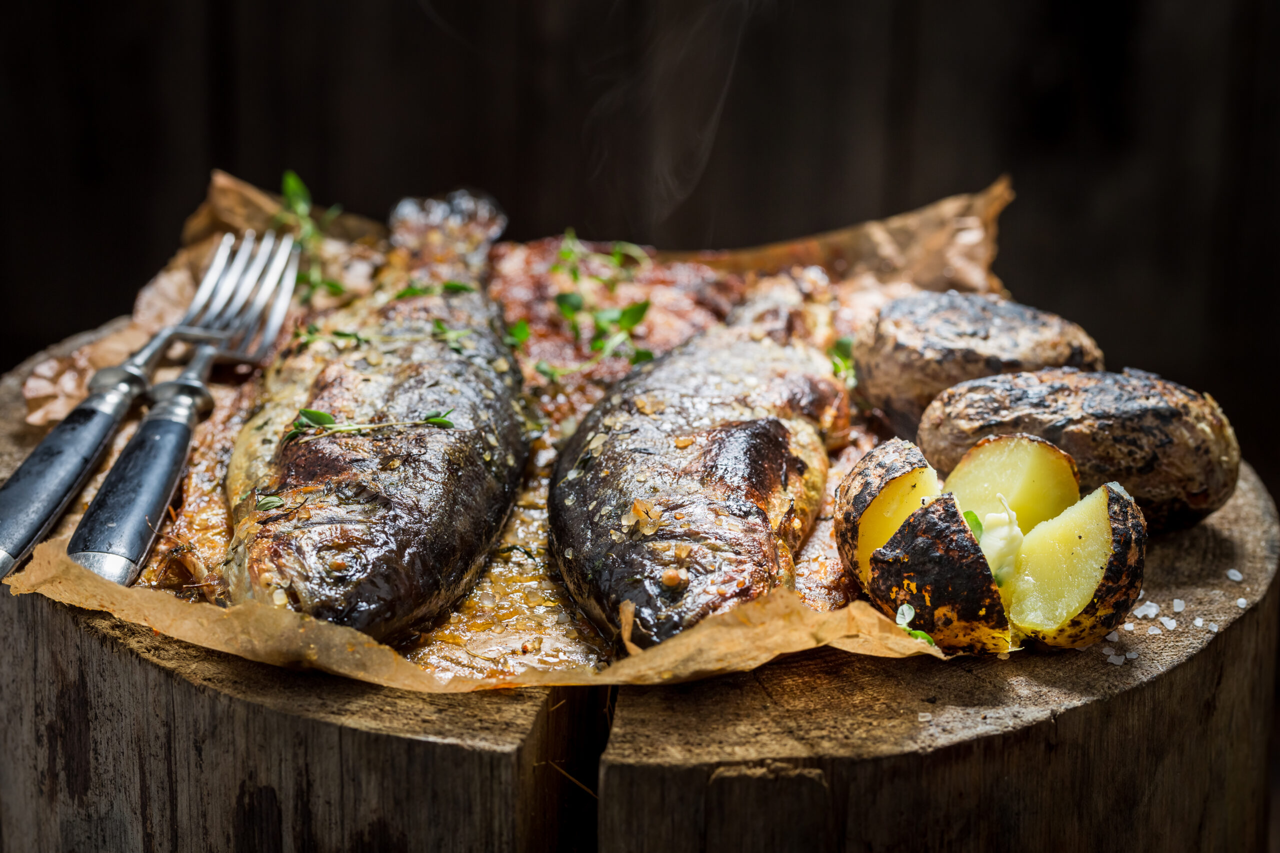 Closeup of fresh potatoes and trout fish with butter